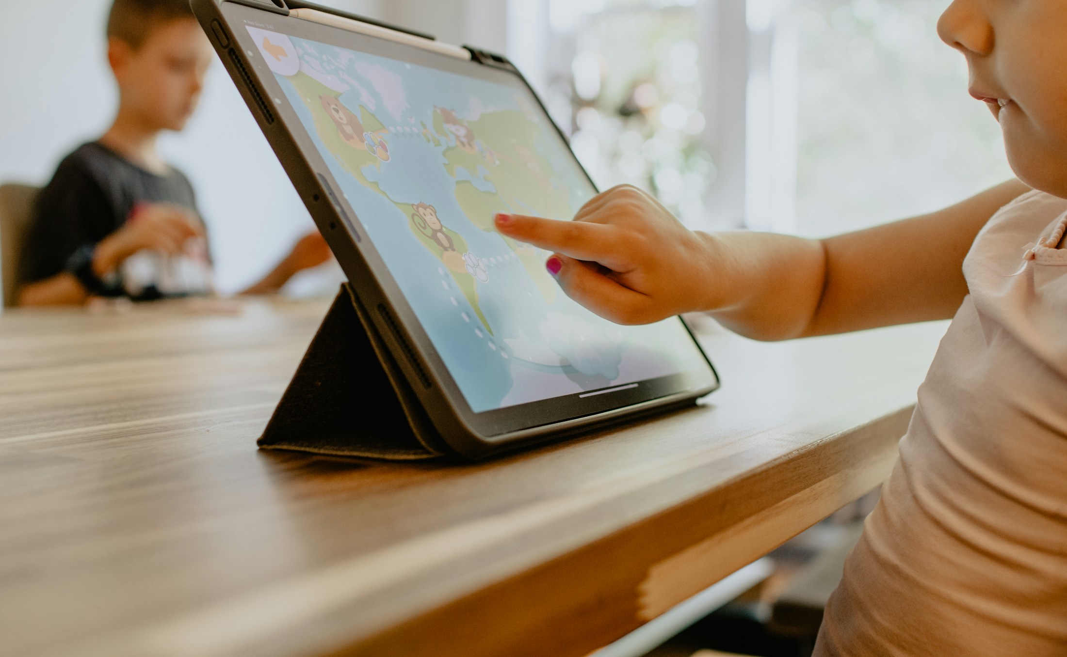 A child using a tablet at a table